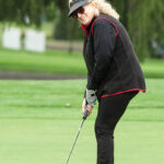 Dale Venturini, RI Hospitality Association President and CEO, lines up her putt.