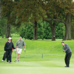 Paul Adams, Susan Colucci (hidden) and Larry Reall watch Jack Coppolino’s chip. All are with the Providence Marriott Hotel.