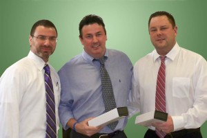 Frank Latorra, Sales Manager at Hartley and Parker, presents Brian Martin and John Hellman, both sales reps, with watches for their 10 year anniversaries.