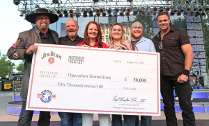 Country duo Montgomery Gentry teamed up with Beam Inc. at the band's Indianapolis show August 15 to present a $50,000 check to Operation Homefront. Eddie Montgomery and Troy Gentry were joined by fellow Kentuckian, Frederick "Fred" Booker Noe III, seventh generation Beam master distiller, Operation Homefront COO Amy Palmer, Army Spec. Dustin Foraker and his wife, Heather Foraker. (PRNewsFoto/Beam Inc.)