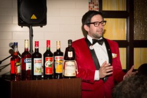 Nick Korn, Italian Spirit Specialist, next to the Campari America portfolio during the Spirited Dinner.