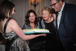 Blowing out candles are co-owners Jean Lester and Regina Lester. 