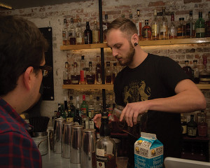 The Cocktail Guru, Jonathon Pogash, as performance judge, looks on as Greg Mayer of The Dorrance creates.