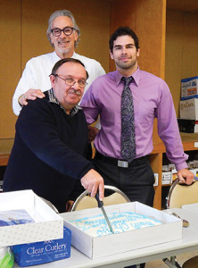 Hartley & Parker President Jerry Rosenberg and Vice President David Rosenberg present Gallant with a cake. 