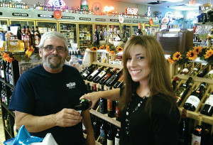 A Vine Venture brand ambassador pours Straccali wines of Tuscany from Palm Bay International at Valencia Liquors in Meriden.