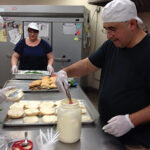 Lynette Lamberti, Human Resource Coordinator, serving lunch at The Thomas Merton House.