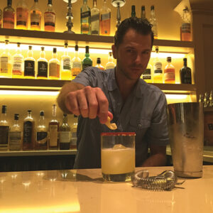 Rob Johnson behind the bar with a Flaming Heart at Cask Republic in New Haven.