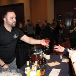 Peter Waite of Bully Boy Distillers serving cocktail samples to guests.