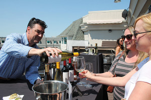 Terry Connaughton, Regional Sales Manager New England, Boisset Collection, pouring a wine sample for Natashia Fortin and Leila Regele, Hilltop Restaurant in Willington.