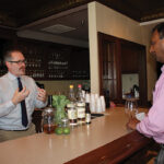 Ed Dunn, Account Development Manager, Brescome Barton talking with Prasad Maganti of Empire Wine and Liquor about the featured spirits, Tequila Cabeza and Cana Brava Rum.