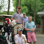 Kneeling: Justin Cyr; James Martin, Owner, 85 Main; (on golf cart) Kevin Cole, Zips Diner and (standing in back) Brian Jodoin.