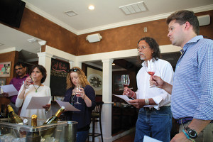 Cori Schott and Carrie Pray, Village Wine and Spirits in Niantic besides C.J. Brady and Gary Williams, Universal Package Store in Noank, during the wine tasting.