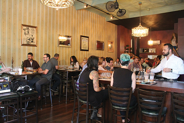 Jordan Bushell addressing guests before the seminar while serving a Hennessy punch.
