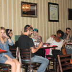 Trade guests examining Aperol for its color and smell before tasting.