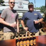 Volunteers Pat McLaine and Dave Heffern pouring Yuengling Oktoberfest for guests.