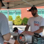 Sean Juliano of Stony Creek Brewery speaking with a guest about their beer.