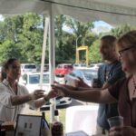 Diana Novak, National Director of Education, Palm Bay International serving samples of The Irishman to David Tristine, Owner, Vines Distinctive and Liz Berry, Employee, Vines Distinctive.