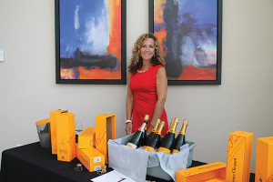 Maureen Pesticci, Compliance Manager, Slocum & Sons beside Vueve Clicquot offerings.