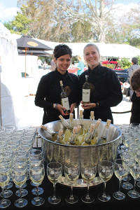 Andreana Dermatis and Nikki Gorman of Blackstone Caterers greeting guests with Robert Mondavi white wine upon entering the festival.