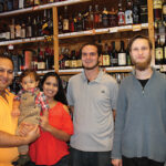 Mihir and Krupa Shah, with their son, and store employees Taylor Jackola and James Medley.