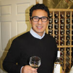 Milton Monzon, Commercial Director, J.C. Imports, holding Vivendo 2014 Reserve Sauvignon Blanc.