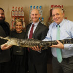 Thomas Mauriello, Brand Ambassador, Bayou Rum; Jennifer Chapin, Director of Sales New England, Stoli Group; Mike Heins, Trade Development Manager, Brescome Barton; and Brett Calkins, Director of Trade Development, Brescome Barton, holding the Bayou Rum mascot.