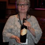 Lynda Ross of The Tasting Company holding Ferrari-Carano Siena of Sonoma County.