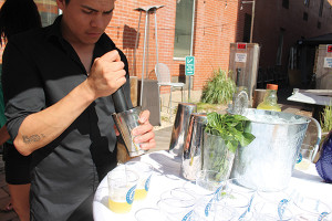 Christtian Hurtado muddling basil leaves for his cocktail “Green Goddess.”