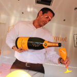 Michael Kolesar, Bar Manager, L’escale inside the Veuve Clicquot Yellow Mailbox Truck pouring champagne samples for guests.