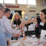 Crissy Peterson from Eder Bros. pouring rosé selections for Nace Schimler, Eli Restaurant Group and Jim and Cindy Lofgren, North End Liquor in Wolcott.