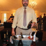 Adam Baker of Allan S. Goodman pouring samples from 14 Hands and Chateau Ste. Michelle.