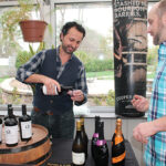 John Tsipouras, Sales Representative, Slocum & Sons pouring tastes for Greg Marcuson, Chef and Owner, Cure Restaurant.