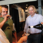 Matt Barcewicz, Connecticut Sales Representative, Michael Skurnik Wines, pouring a sample for Christopher and Melissa Jeans of Casa Bacchus Wine Shoppe in Litchfield.