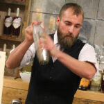 Production Manager William Leach mixing cocktails for guests during the opening.