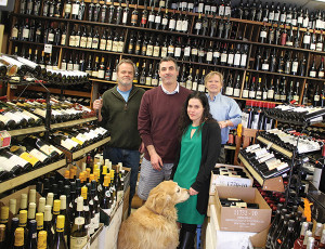 Rob Vickers, Co-Owner; Mike Paradis, Store Manager; Elizabeth Moniz, Store Employee; and Mike Vickers, Co-Owner. Rocky the retriever is the foreground.