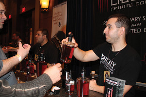 Bryan Ricard of Sons of Liberty Spirits discussing the portfolio, Founder and President Mike Reppucci is seen in the background.