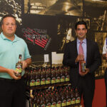 Steve Drew, Business Manager, CDI; Marco Pelliccio, State Manager, Beam Suntory; Steve Baye, Vice President of Business Management and Marketing, CDI with Jim Bean Apple.