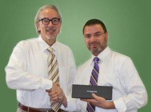 Jerry Rosenberg, President of Hartley and Parker, presents Frank Latorra, Sales Manager, with a watch for his 10 year anniversary. 