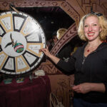 Kirsten Amann, Fratelli-Branca’s Fernet Brand Champion spins the wheel on a game used for members to earn their coin.