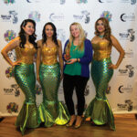 Mermaid models with Nadine Gengras, Account Development Specialist - Spirits, Connecticut Distributors, Inc., at the “selfie station.” Gengras organized Sugar Island Rum’s participation in the event.