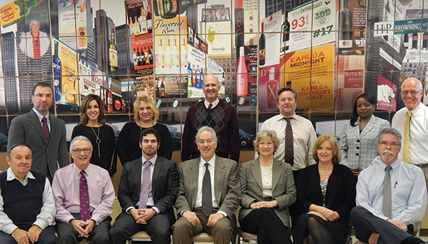 Hartley & Parker's management team, 2015. Back Row: Frank LaTorra, Sales Manager; Carla Sager, Graphic Design Manager; Paula Latham, Accounting Manager; Mike Bylo, Controller; Bill Saroka, Wine Director; Althea Alexander, Credit Manager; and Blaise Tramazzo, Spirit Director. Front Row: Donnie Gallant, Warehouse Manager; Paul Angelico, General Sales Manager; David Rosenberg, Vice President; Jerry Rosenberg, President; Mindy Rosenberg, Assistant to the President; Joyce Halkowicz, Customer Service Supervisor; Gary William, IT Manager. Missing from photo: Pat Oates, Warehouse Manager and Murray Smiling, Night Crew Manager.