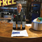 Frank Conklin, Store Associate, Stew Leonard’s Norwalk with featured wines, Amethystos and Santorini wines.