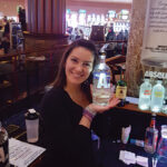 Brittany Frey, Bartender, Twin River Casino, working at the Absolut satellite bar during the New Year’s Eve celebration at Lighthouse Bar. Frey is holding the new bottle design of Absolut vodka.