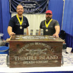 Thimble Island Brewing Company’s Alexander Brown, Sales Representative and Dave Morgan, Lead Sales Representative, at the Rhode Island International Craft Beer Festival at the Providence Convention Center, where the brewery received two third place medals for its American Ale and Thimble Lager.