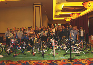 Twin River Casino employees and volunteers refurbishing bikes. Frank Martucci, General Manager, Beverage Operations at Twin River Casino, shown third from right.