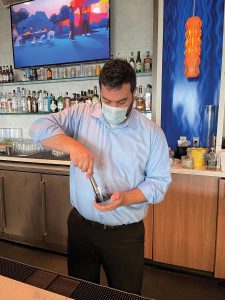 Operations Manager Josh Feliciano with the Blackberry Gin and Tonic.