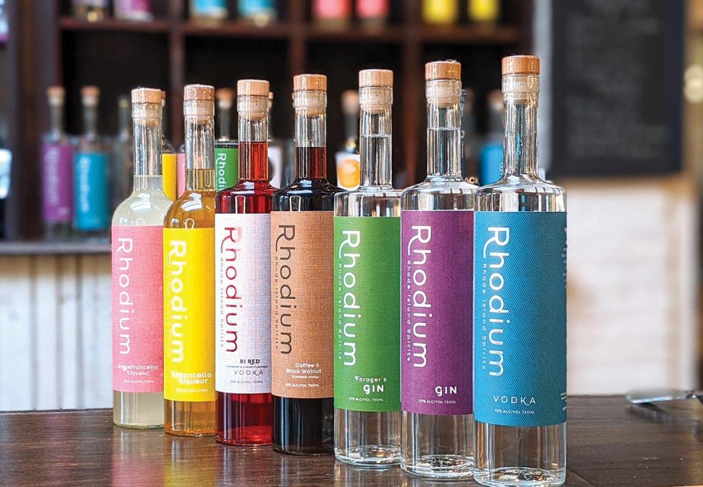 Shown from the RI Spirits lineup: Rhodium Grapefruitcello, Rhodium Limoncello, Rhodium RI Red Vodka, Rhodium Coffee Walnut Vodka, Rhodium Foragers Gin, Rhodium Gin and Rhodium Vodka
