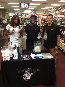 Shown with a Remy V model are Charlamagne tha God and Giancarlo Cowan, Multi-Cultural Key Account Manager, Brescome Barton at Bridgeport’s Price Break Liquors.