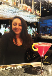 Samantha LaPoint, Bartender, Eleven 49, next to "Flower Power" cocktail.