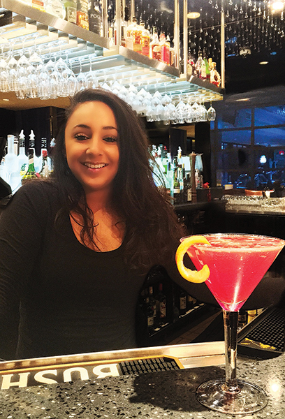 Samantha LaPoint, bartender, Eleven 49, next to "Flower Power" cocktail.